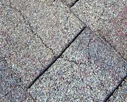 Cracked asphalt roofing shingles